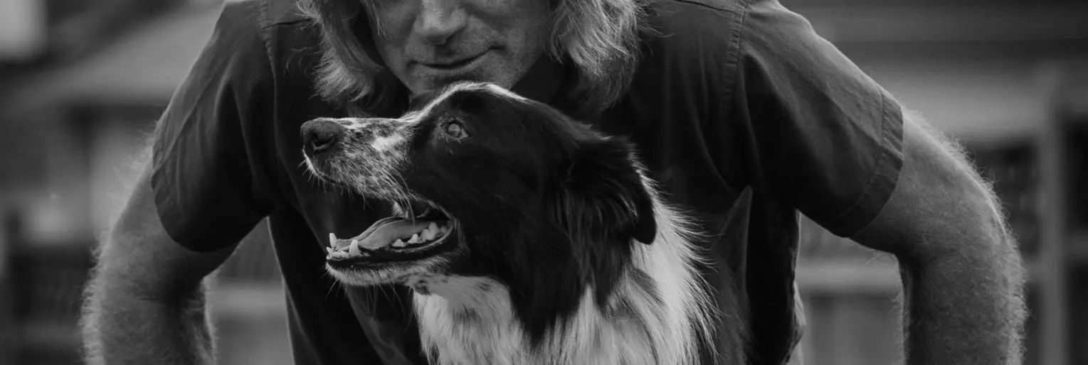 Man with dog, black and white photo.