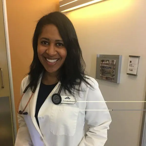 Doctor smiling in hospital hallway