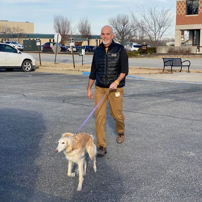 Person with dog on leash outdoors