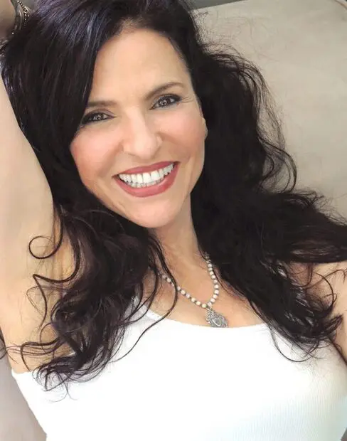Cheerful brunette woman lounging on a sofa.