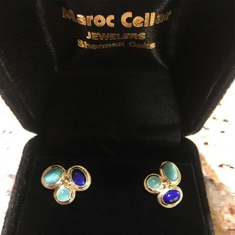 Blue gemstone earrings displayed in velvet box