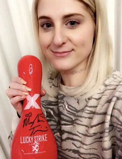 Smiling woman with red bowling pin